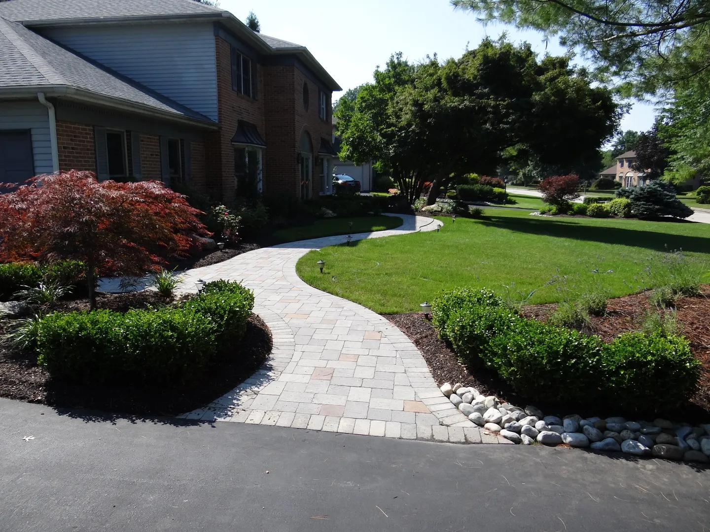stone pathway going to the front door of a house